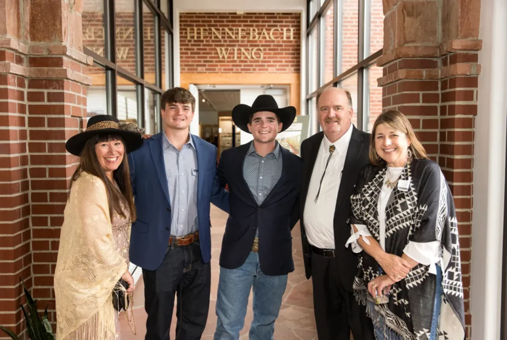 Group of 5 people posing in front of Hennebach Wing