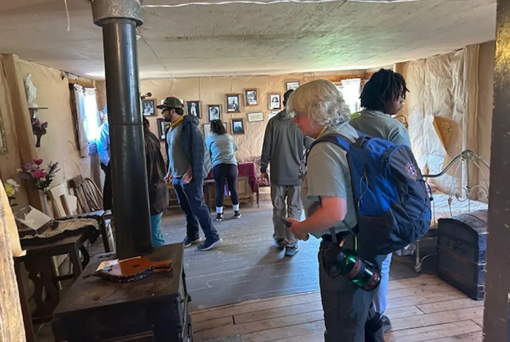 Tour attendees exploring the superintendents cabin at The Matchless Mine